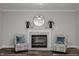 Elegant fireplace with a marble surround and stylish armchairs at 341 Harts Creek Dr Dr, Pittsboro, NC 27312
