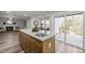 Kitchen island with sink, granite countertops and hardwood floor at 341 Harts Creek Dr Dr, Pittsboro, NC 27312