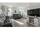 Living area with gray reclining sofas, media console, and large TV at 386 Cotton Brook Dr, Fuquay Varina, NC 27526