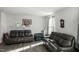 Spacious living room with comfortable sofas and large windows at 386 Cotton Brook Dr, Fuquay Varina, NC 27526