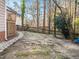 Backyard with a flagstone path, wooden fence, and mature trees at 4405 Liverpool Ln, Raleigh, NC 27604