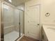 Bathroom featuring a single sink vanity, a large mirror, and a tile shower behind a glass door at 494 Traditions Grande Blvd # 25, Wake Forest, NC 27587