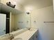 Bathroom featuring a double sink vanity, a large mirror, and a tile shower behind a glass door at 494 Traditions Grande Blvd # 25, Wake Forest, NC 27587