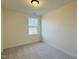 Bedroom with carpet flooring, neutral walls and trim, and a window that provides ample natural light at 494 Traditions Grande Blvd # 25, Wake Forest, NC 27587