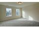 Well-lit bedroom features neutral carpet and walls, two windows that provide ample natural light at 494 Traditions Grande Blvd # 25, Wake Forest, NC 27587