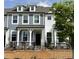 Charming two-story townhome with gray and white siding, dormer windows, and a black wrought iron fence at 494 Traditions Grande Blvd # 25, Wake Forest, NC 27587