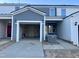 New construction townhome with open garage and red front door at 494 Traditions Grande Blvd # 25, Wake Forest, NC 27587