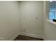 Bright hallway featuring wood flooring and neutral walls with an electrical outlet at 494 Traditions Grande Blvd # 25, Wake Forest, NC 27587
