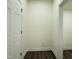 Hallway featuring white trim and neutral walls with wood flooring at 494 Traditions Grande Blvd # 25, Wake Forest, NC 27587