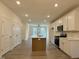 Bright kitchen with modern appliances, an island, and white cabinets offering a clean, contemporary look at 494 Traditions Grande Blvd # 25, Wake Forest, NC 27587