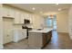 Well-lit kitchen featuring stainless steel appliances, a kitchen island, and stylish backsplash at 494 Traditions Grande Blvd # 25, Wake Forest, NC 27587