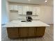 Spacious kitchen features a large island with countertop, sleek appliances, and ample cabinet space at 494 Traditions Grande Blvd # 25, Wake Forest, NC 27587