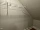 A small attic closet features wire shelving for added storage space and organization at 496 Traditions Grande Blvd # 24, Wake Forest, NC 27587