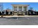 Community clubhouse with stone accents, large windows, and manicured landscaping at 496 Traditions Grande Blvd # 24, Wake Forest, NC 27587