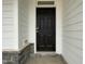 Classic black front door with digital lock, enhanced by stone accents and white siding at 496 Traditions Grande Blvd # 24, Wake Forest, NC 27587