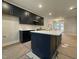 Stylish kitchen showcasing an island with elegant countertop, and contemporary fixtures at 496 Traditions Grande Blvd # 24, Wake Forest, NC 27587