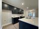 Modern kitchen featuring sleek black cabinets, stainless steel appliances, and a spacious island at 496 Traditions Grande Blvd # 24, Wake Forest, NC 27587