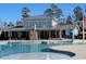 Community pool with waterfall feature and clubhouse with stone chimney at 496 Traditions Grande Blvd # 24, Wake Forest, NC 27587