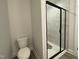 A modern bathroom featuring a sleek glass shower with marble-look tiles and contemporary fixtures at 498 Traditions Grande Blvd # 23, Wake Forest, NC 27587