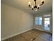 Bright dining area featuring a modern chandelier and convenient access to the outdoor patio at 498 Traditions Grande Blvd # 23, Wake Forest, NC 27587