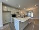 Modern kitchen features a large island with quartz countertops, stainless steel appliances, and ample cabinetry at 498 Traditions Grande Blvd # 23, Wake Forest, NC 27587