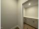 Well-lit pantry with counter space and storage cabinets, enhancing kitchen organization at 498 Traditions Grande Blvd # 23, Wake Forest, NC 27587