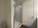 Modern glass shower with sleek gray tile and fixtures, adjacent to a white door at 500 Traditions Grande Blvd # 22, Wake Forest, NC 27587