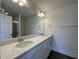 Bathroom featuring granite countertops with double sinks, a large mirror, and modern fixtures at 500 Traditions Grande Blvd # 22, Wake Forest, NC 27587