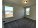 Bright bedroom featuring plush carpet, light walls, and ample natural light from two windows at 500 Traditions Grande Blvd # 22, Wake Forest, NC 27587