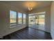 Bright dining area with dark hardwood floors, three windows, and access to the patio at 500 Traditions Grande Blvd # 22, Wake Forest, NC 27587