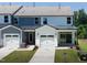 Townhome style home featuring a white garage door and neutral siding at 500 Traditions Grande Blvd # 22, Wake Forest, NC 27587