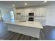 Kitchen featuring granite island, stainless steel appliances and white cabinetry at 500 Traditions Grande Blvd # 22, Wake Forest, NC 27587