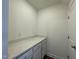 Laundry room features granite countertops and lower white cabinets at 500 Traditions Grande Blvd # 22, Wake Forest, NC 27587