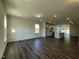 Spacious living room with dark wood floors and views into the kitchen and backyard at 500 Traditions Grande Blvd # 22, Wake Forest, NC 27587