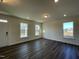 Living room with dark hardwood floors, natural light, and white trim at 500 Traditions Grande Blvd # 22, Wake Forest, NC 27587