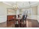 Formal dining room with hardwood floors, chandelier, and large windows at 5705 Jabbo Ct, Wake Forest, NC 27587