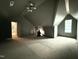 Spacious attic space featuring an interesting ceiling and a window offering natural light at 7013 Buckhead Dr, Raleigh, NC 27615