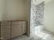 Bathroom with marble tiled shower and floors, and unfinished vanity at 7013 Buckhead Dr, Raleigh, NC 27615