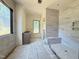 Bathroom featuring a window, vanity, and tiled shower with a seat at 7013 Buckhead Dr, Raleigh, NC 27615