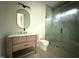 Bathroom featuring a shower with a glass door, sleek fixtures, and a modern vanity at 7013 Buckhead Dr, Raleigh, NC 27615