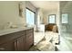 Bathroom with double vanities, tile backsplash, and glass-enclosed shower at 7013 Buckhead Dr, Raleigh, NC 27615