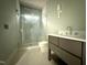 Bathroom featuring a glass shower with a built-in seat and a modern vanity at 7013 Buckhead Dr, Raleigh, NC 27615