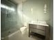 Bathroom featuring a glass shower with a built-in seat and a modern vanity at 7013 Buckhead Dr, Raleigh, NC 27615
