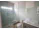 Well-lit bathroom with glass-enclosed shower, modern vanity, and elegant sconces offers a relaxing space at 7013 Buckhead Dr, Raleigh, NC 27615