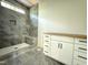 Bathroom with marble tiled shower featuring a bench seat, and a white vanity at 7013 Buckhead Dr, Raleigh, NC 27615