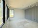 Large unfinished bedroom features large windows for natural light and grey accent wall at 7013 Buckhead Dr, Raleigh, NC 27615