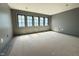 Large unfinished bedroom features large windows for natural light and gray paint at 7013 Buckhead Dr, Raleigh, NC 27615