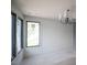 Bright bedroom with ample natural light from large windows and a modern chandelier for added elegance at 7013 Buckhead Dr, Raleigh, NC 27615