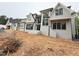 Newly constructed home features a gray painted brick exterior, black framed windows, and modern architectural design at 7013 Buckhead Dr, Raleigh, NC 27615