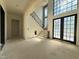 Grand foyer with staircase, large windows and double glass doors offering lots of natural light at 7013 Buckhead Dr, Raleigh, NC 27615